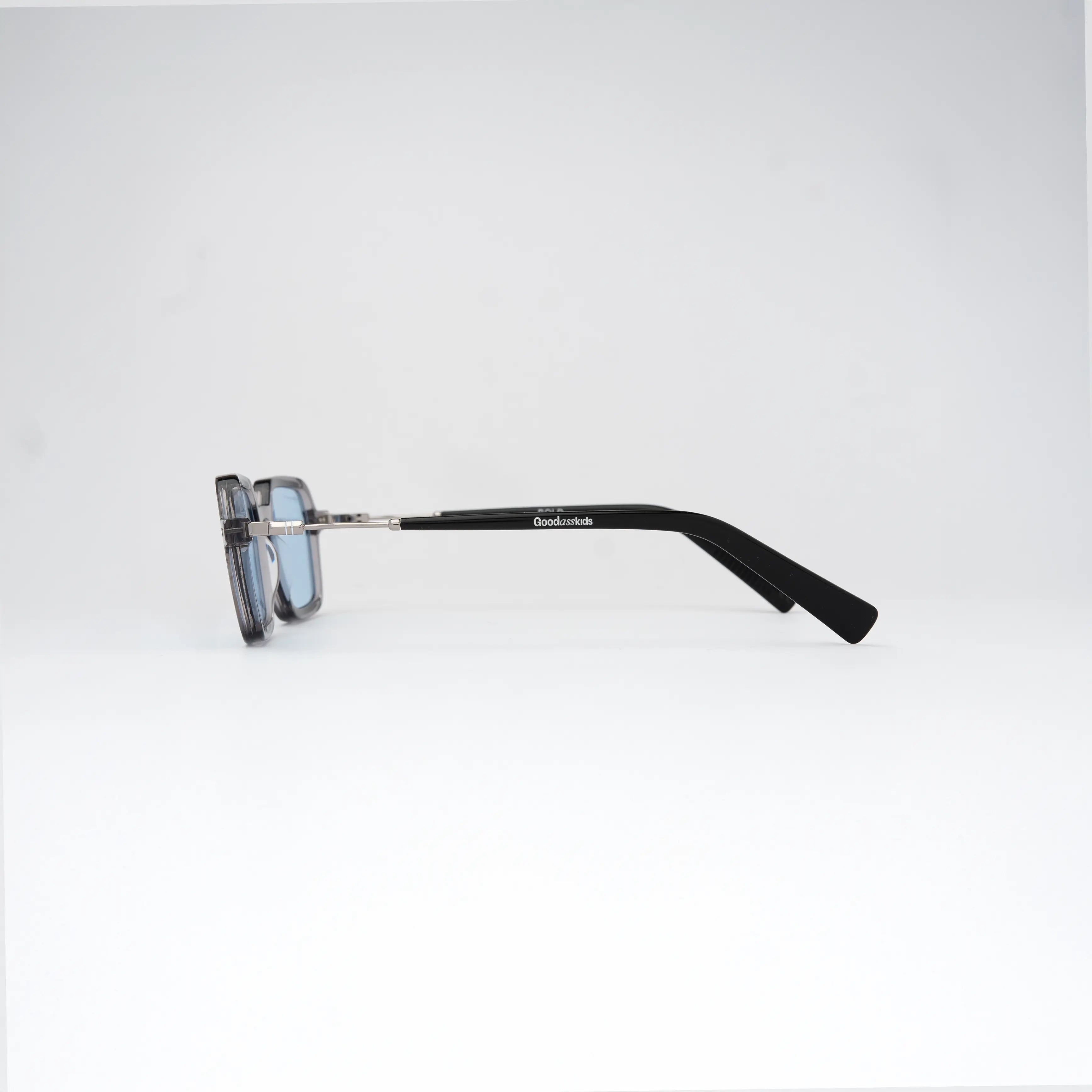 Bold Silver Sunglasses showcasing a side profile with defined angles and soft curves, highlighting premium acetate construction.