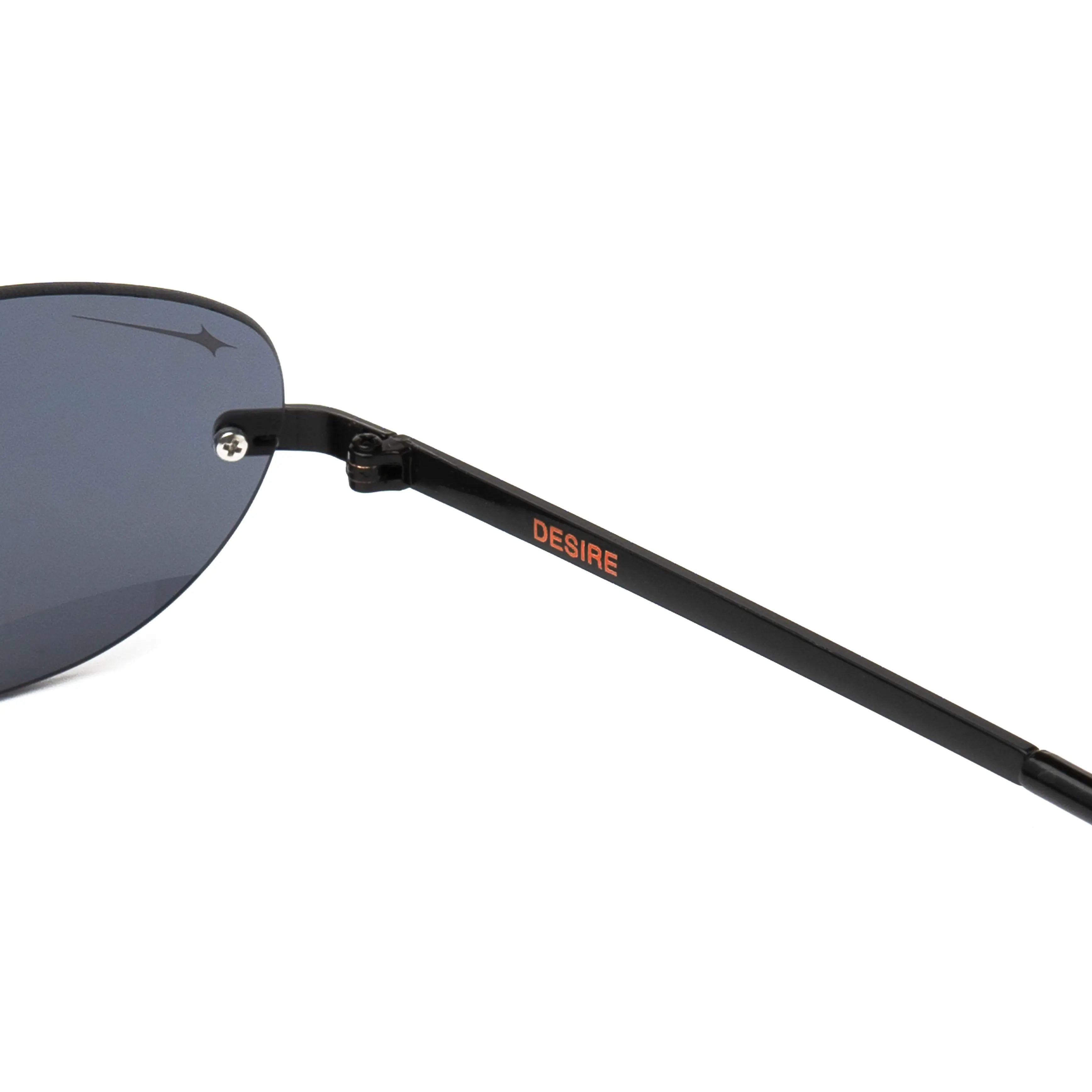 Desire Caviar Black Sunglasses close-up showing metal frame and logo detail.