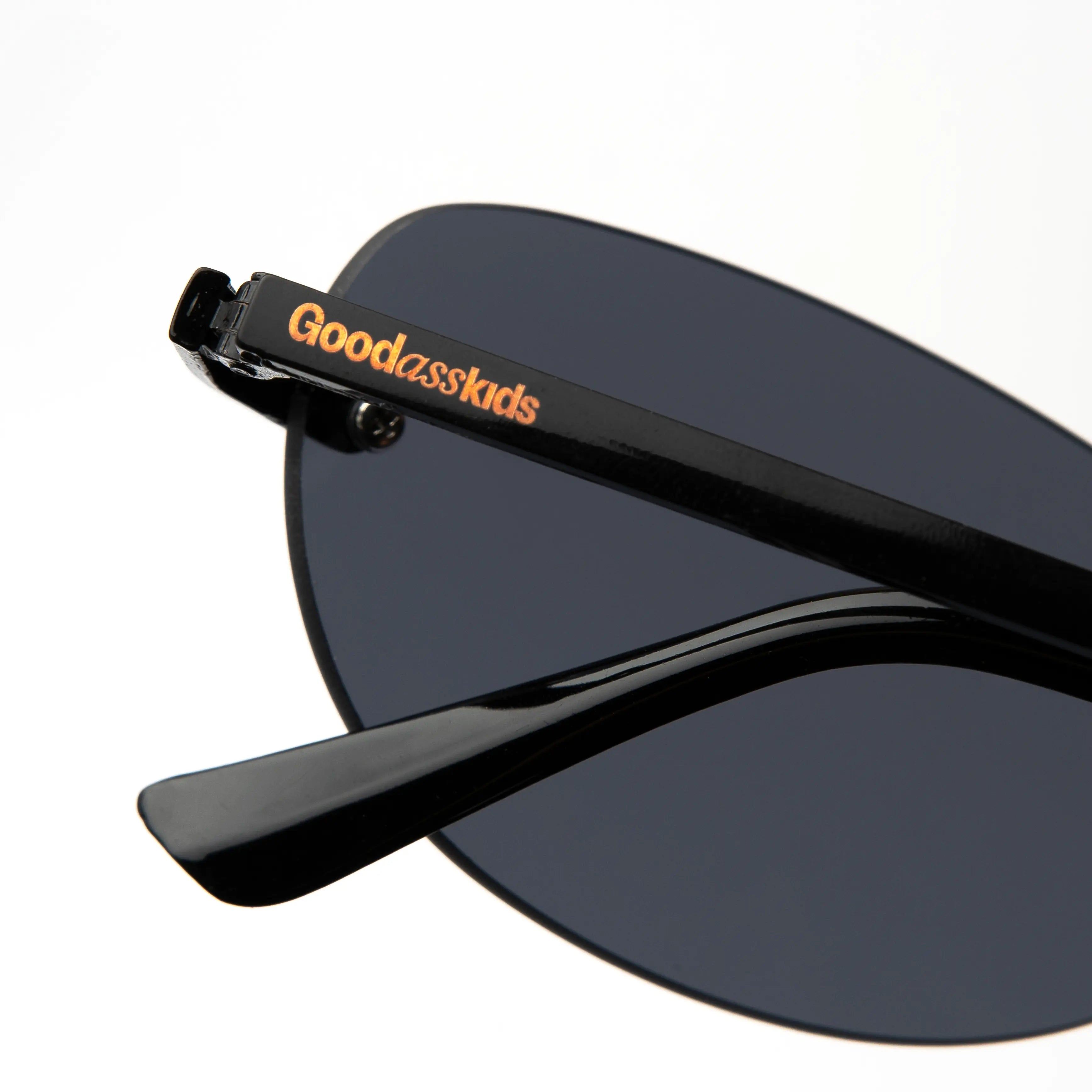 Desire Caviar Black Sunglasses close-up detail with a sleek black frame and dark lenses.