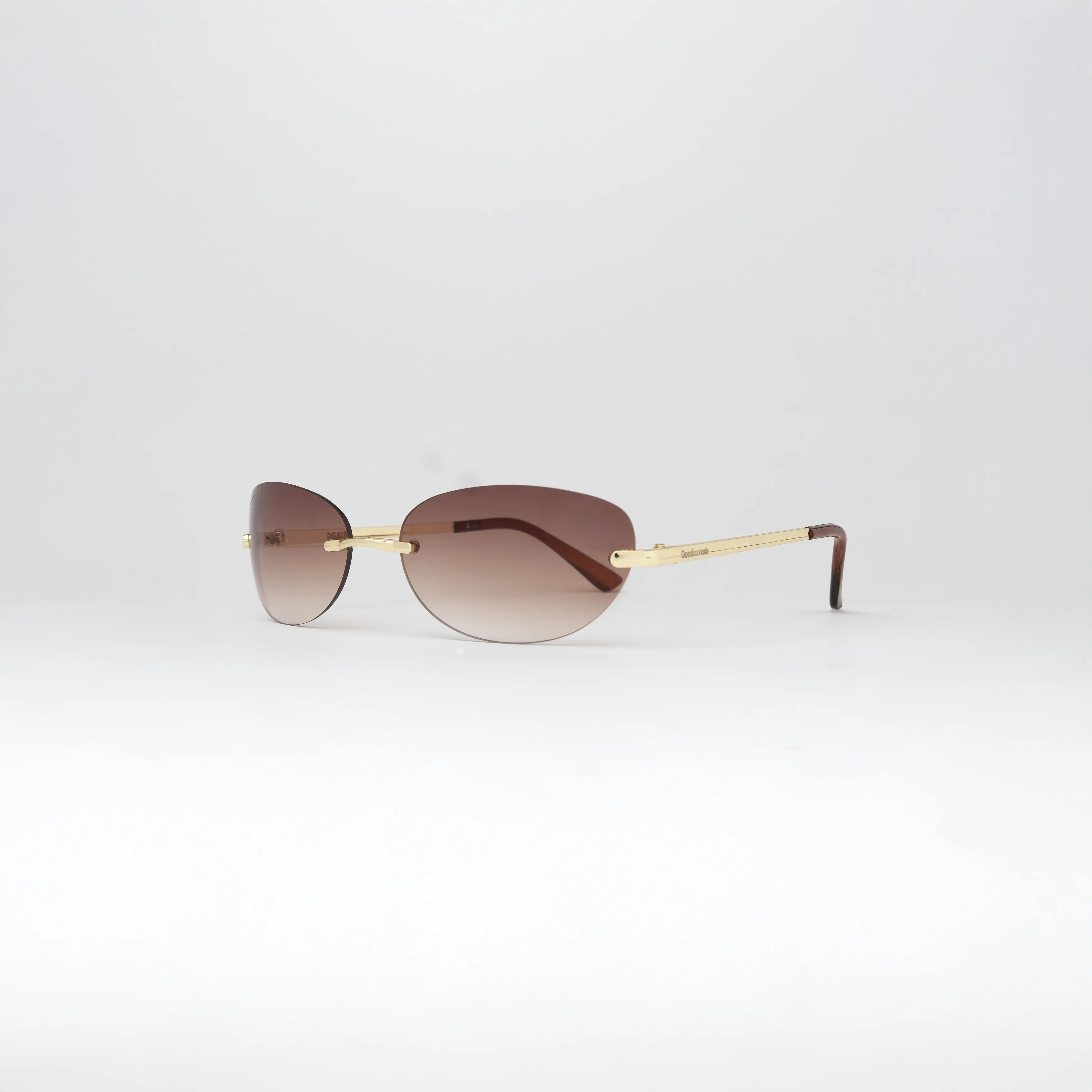 Side view of Desire Sugar Brown Sunglasses showcasing the slim gold temple and comfortable fit.