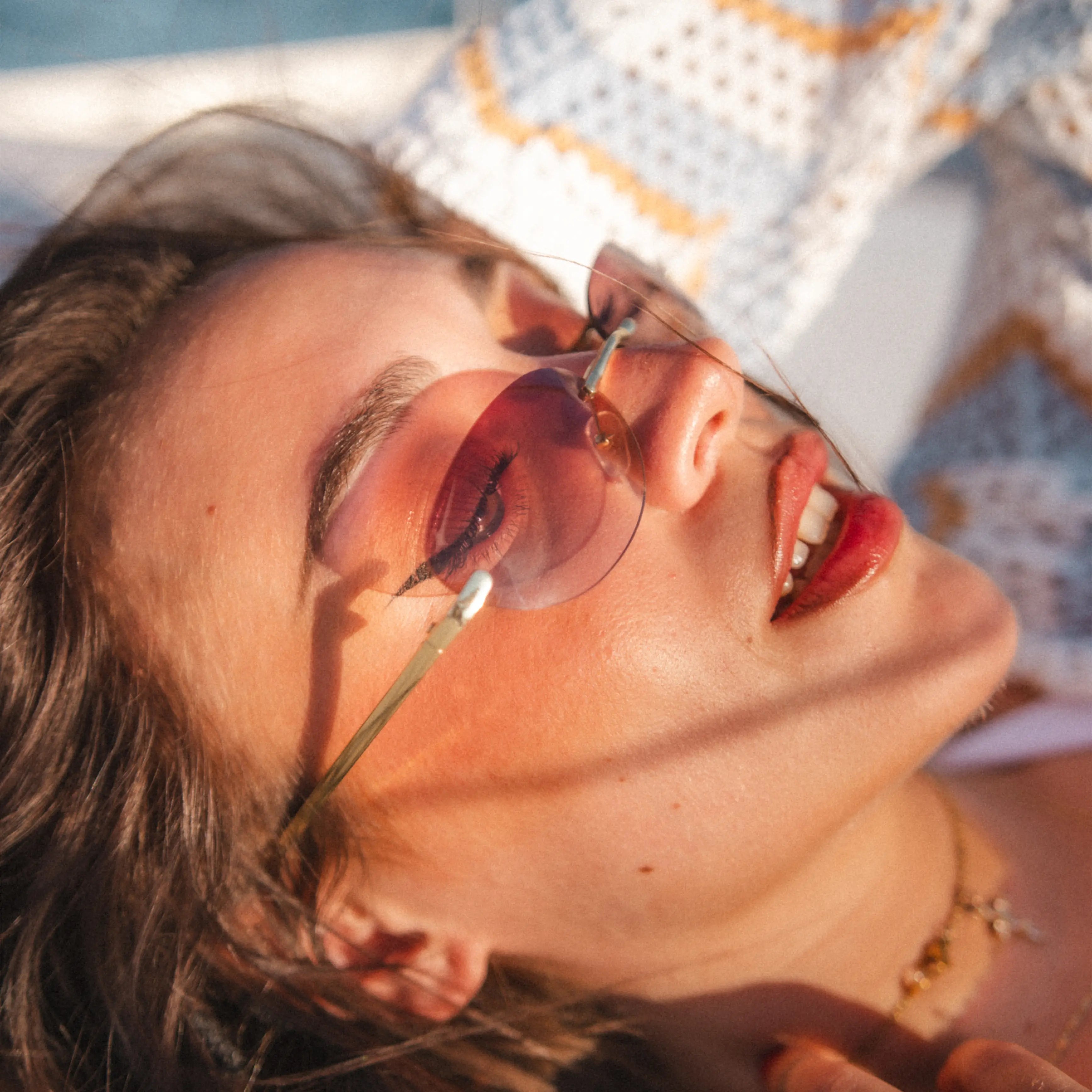 Model wearing Desire Sugar Brown Sunglasses outdoors, brown lenses and gold frame for effortless street style.